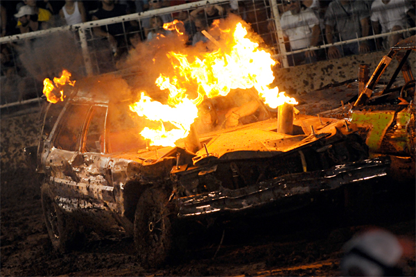 Fire erupts from a car at a demolish derby.